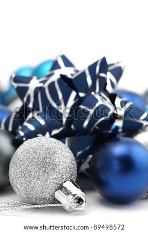 Fancy bow with blue and silver Christmas ornaments isolated on white background. Shallow dof