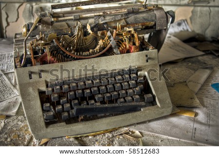 Image of an old, vintage rusty typewriter in a derelict abandoned police station covered in dust.