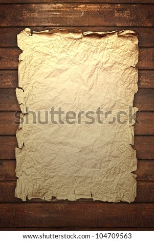 grunge background - old broken paper on brown wooden board