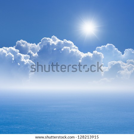 Peaceful background - blue sea and sky, white clouds, bright sun - heaven