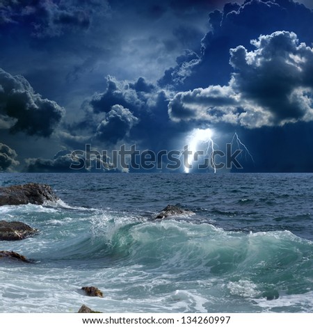 Dramatic nature background - lightnings in dark sky, stormy sea