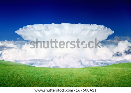 Peaceful eco landscape - green grass field, hills, blue sky, big white incus cloud