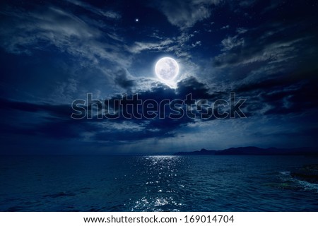Night sky with full moon and reflection in sea, stars, beautiful clouds. Elements of this image furnished by NASA