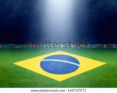 Soccer stadium at night, brazil flag on green soccer field, world soccer event