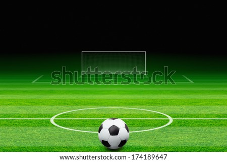 Sports background - soccer ball, green soccer field, soccer stadium at night, soccer goal