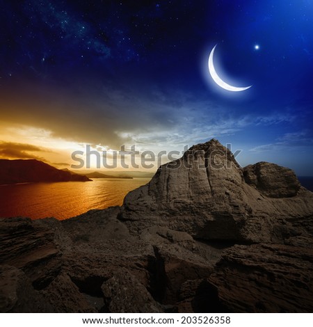 Ramadan background - moon and stars above mountain, holy month, beautiful red sunset over sea. Elements of this image furnished by NASA