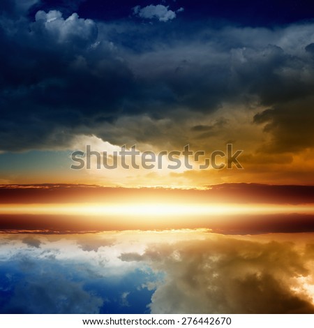 Beautiful red sunset, glowing horizon, clouds with reflection