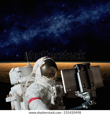 Astronaut taking selfie photo on planet Mars, mission to Mars. Elements of this image furnished by NASA nasa.gov