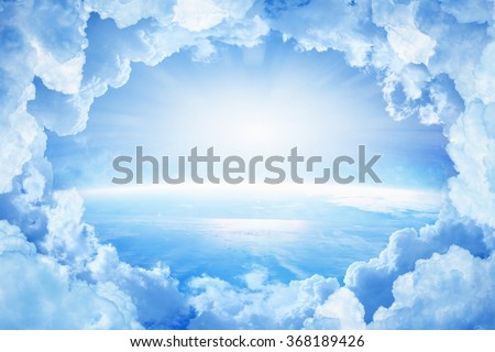 Light from heaven, blue planet Earth in white clouds, bright sunlight from above. Elements of this image furnished by NASA nasa.gov