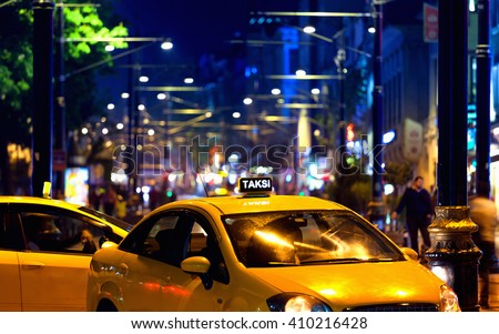 Yellow turkish taxi car with colourful bokeh of city lights