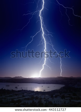 Weather background - bright powerful lightning, huge thunderbolt struck mountain near small seaside city