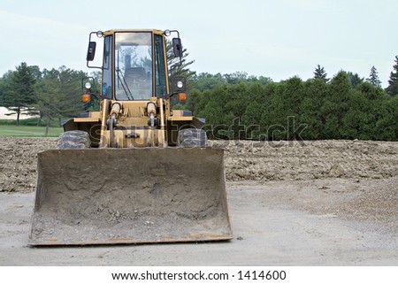 Bull dozer on job site with room at right for text