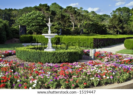 Saturated garden scene.  Fountain, hedges, flowers - public park and cemetery