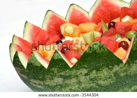 A fruit salad inside the carved shell of a watermelon