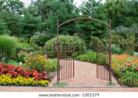 Beautiful floral garden with decorative wrought iron gate.