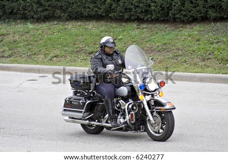 A motorcycle police officer on patrol.