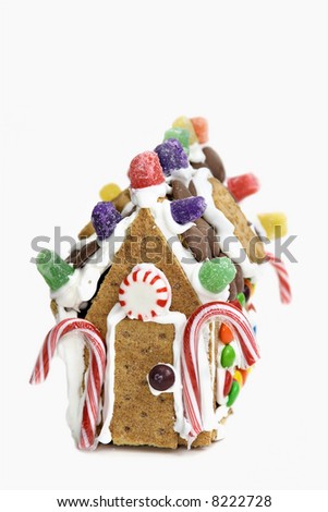 A house made of various confections - cookies, crackers, candies and royal icing.