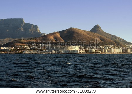 Capetown from offshore with Table Mountain and Signal Hill in the background and Green Point Stadium in the foreground.
