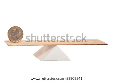 Euro coin balance on wooden board