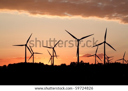 Silhouette of wind power station on sunset