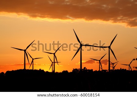 Silhouette of wind power station on sunset