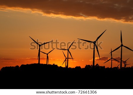 Silhouette of wind power station on sunset