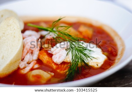 Typical dish of Baltic countries: fish soup with tomato and aioli sauce, served with white bread. Shallow depth of field