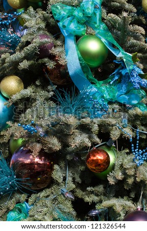 Ribbons, balls, and lights decorate an outdoor tree in Santa Fe, New Mexico