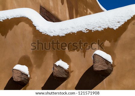 Snow piles up on Santa Fe\'s vigas and adobe walls in winter