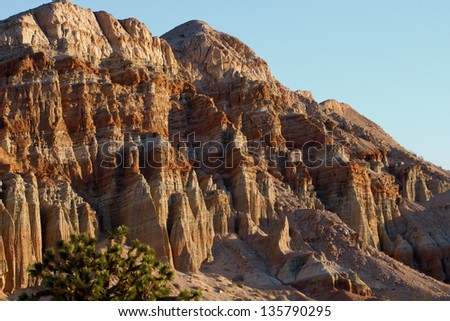 Dawn lights a rock wall at Red Rock Canyon State Park and Red Cliffs Nature Preserve in California\'s Mohave Desert
