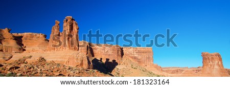 The Three Gossips cast a shadow in Arches National Park