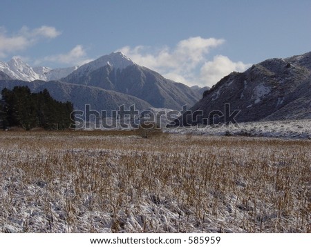 Winter Snowy mountain peaks with snow field in Valley. Copy space on snow field