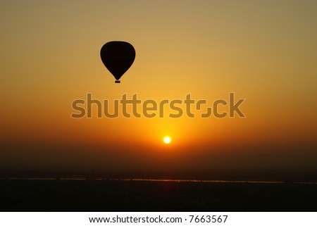 Hot air balloon with setting sun over Egypt