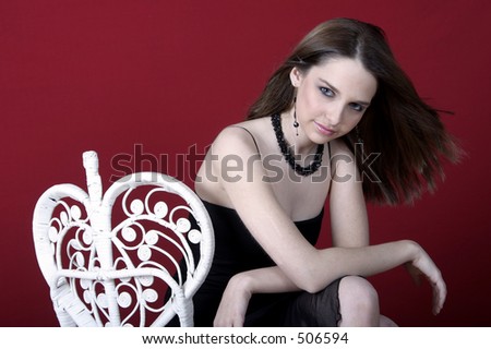 young woman posed on chair