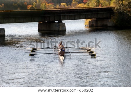Crew rowing team on river