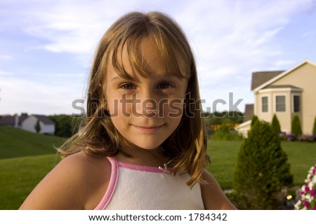 Closeup of a grade-school age girl outside during the summer.