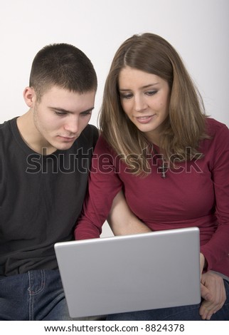 Young couple looking at a laptop computer together