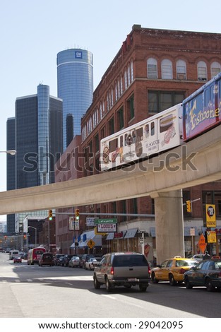DETROIT - April 11, 2009 - With the headquarters of the financially ailing General Motors in the background, the People Mover crosses a street in Detroit\'s Greektown. GM is facing possible bankruptcy.