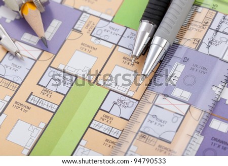 Closeup of paper showing home plan  along with drawing tools.