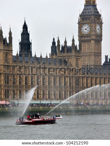 LONDON - JUNE 3rd 2012: A fire boat shoots water during Queen Elizabeth Diamond Jubilee River Pageant on June 3rd 2012 in London