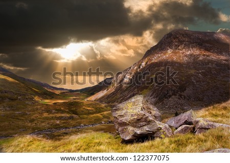 Inspirational sunburst over mountain range landscape