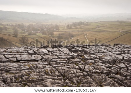 Autumn morning over limestone pavement at Malham Cove looking along Malham Dale in Yorkshire Dales National Park