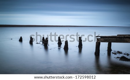 Long exposure landscape of old jetty extending into lake