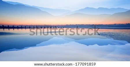 Double exposure effect of mountains and sunrise beach landscape