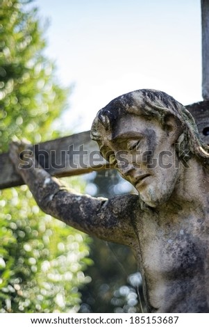 14th century stone statue Jesus on cross