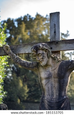 14th century stone statue Jesus on cross