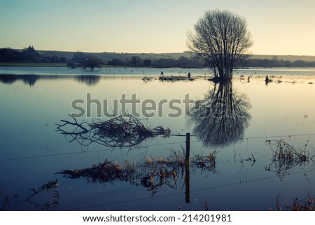 Beautiful landscape of flood plains in Winter with mirror reflections