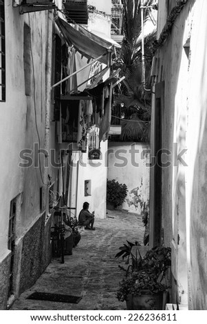 Mediterranean alley way between old houses and buildings  black and white