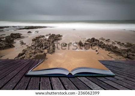 Long exposure landscape beach scene with moody sky conceptual book image