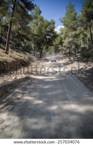 Off road vehicle on road through dense foliage on Mediterranean island Ibiza